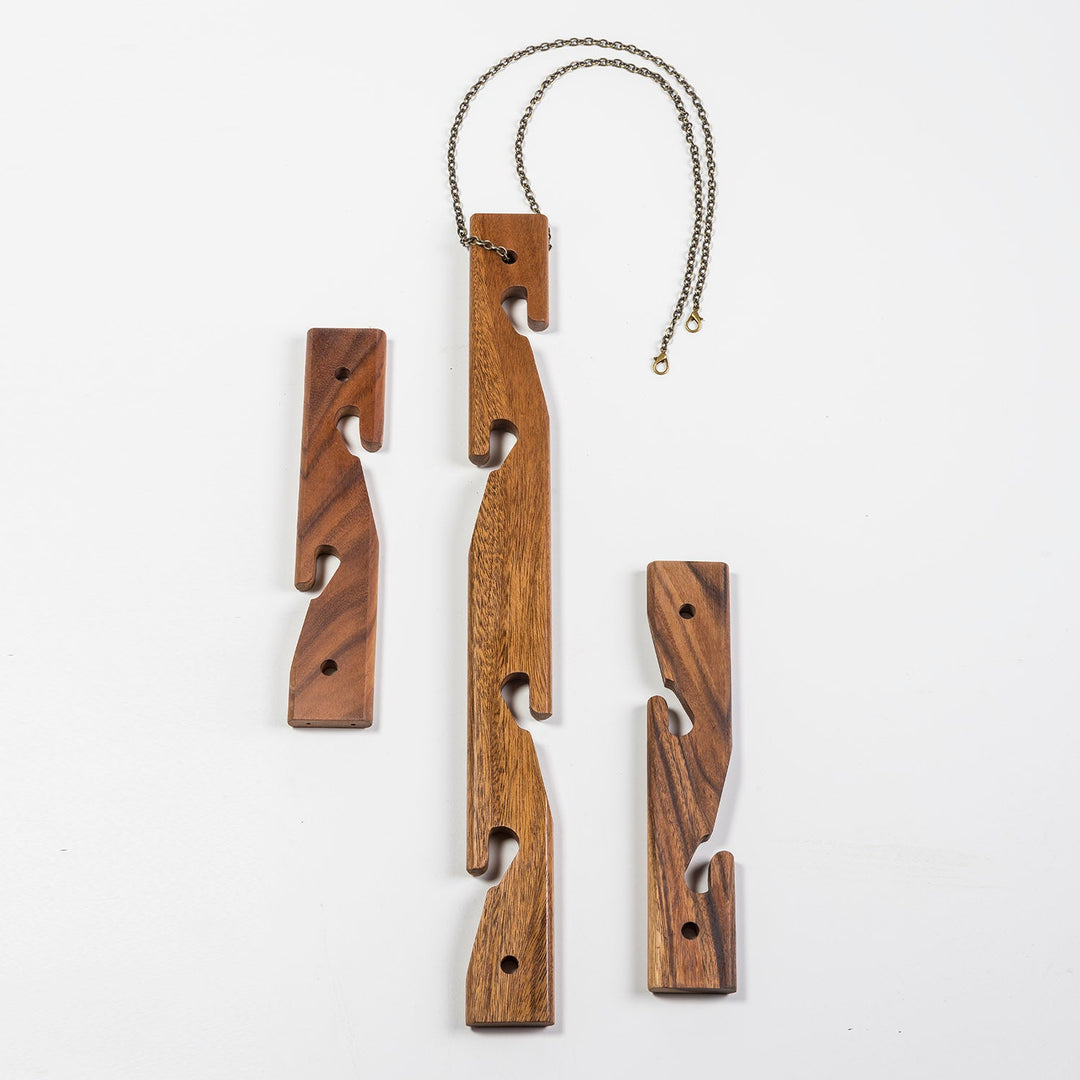Set of three acacia wood hanging plant holders that display up to six pots.