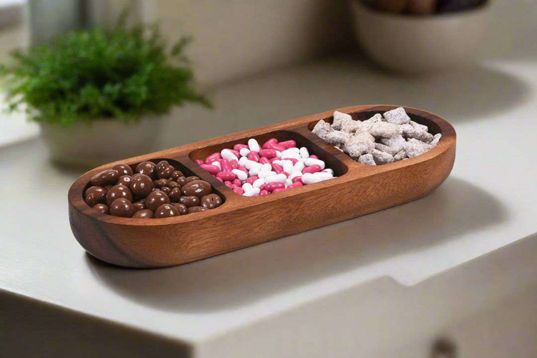 Acacia wood three-compartment candy and nut tray with a natural finish.