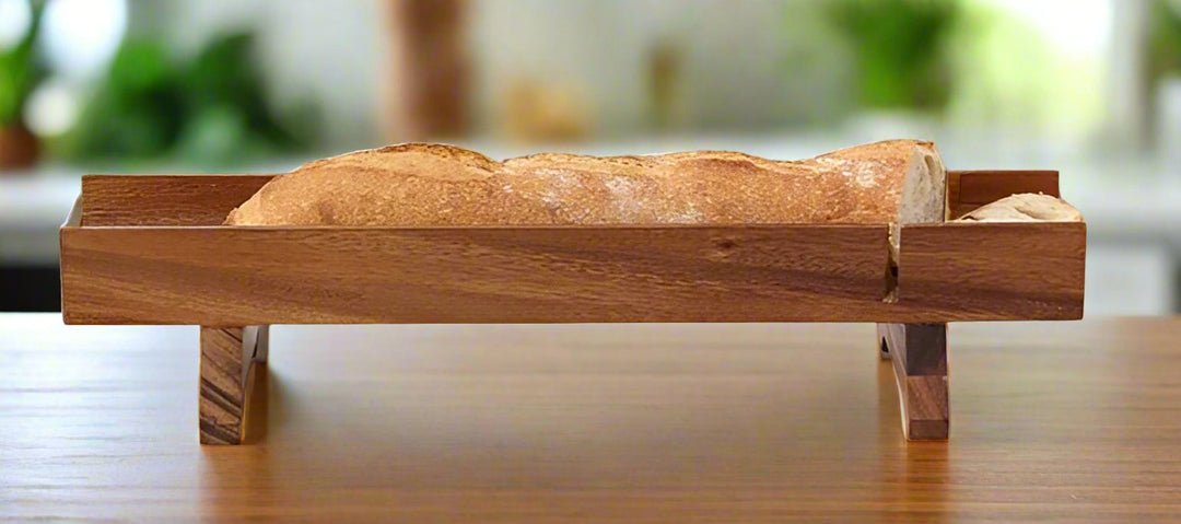 Acacia wood French bread slicer with slots to guide even cuts on baguettes.