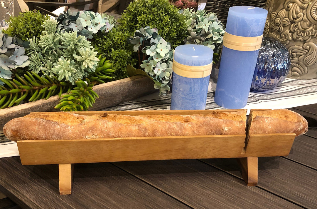 Acacia wood French bread slicer with a raised design for easy slicing.