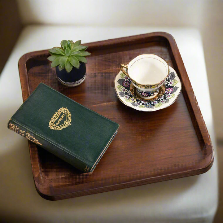 15-inch square acacia wood serving tray with side handles for serving food.