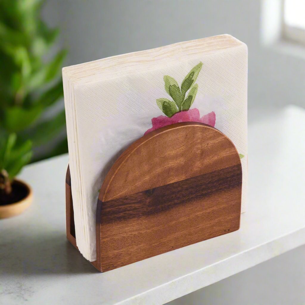 Vertical acacia wood napkin holder for organizing napkins on a countertop.