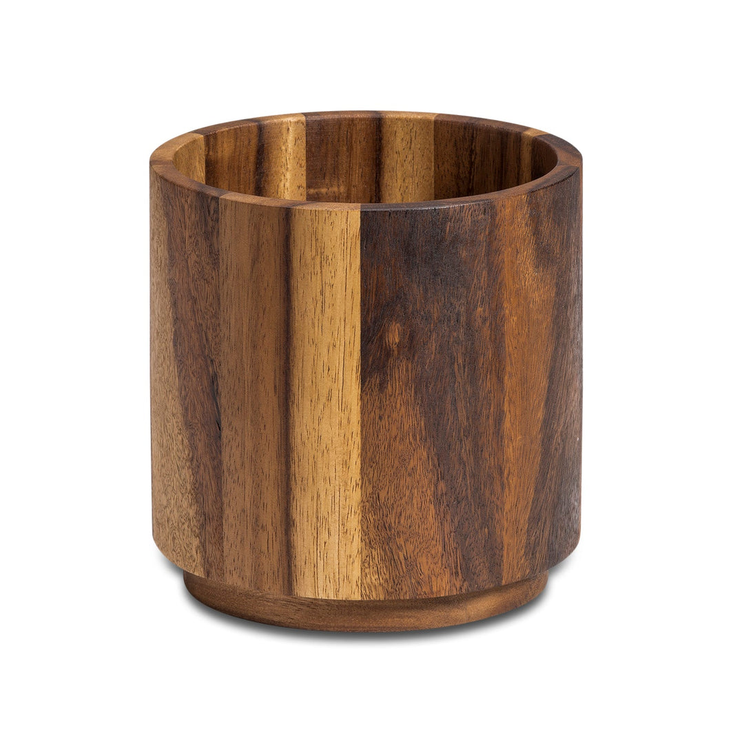 Acacia wood rotating lazy Susan utensil holder for utensils and cutlery.
