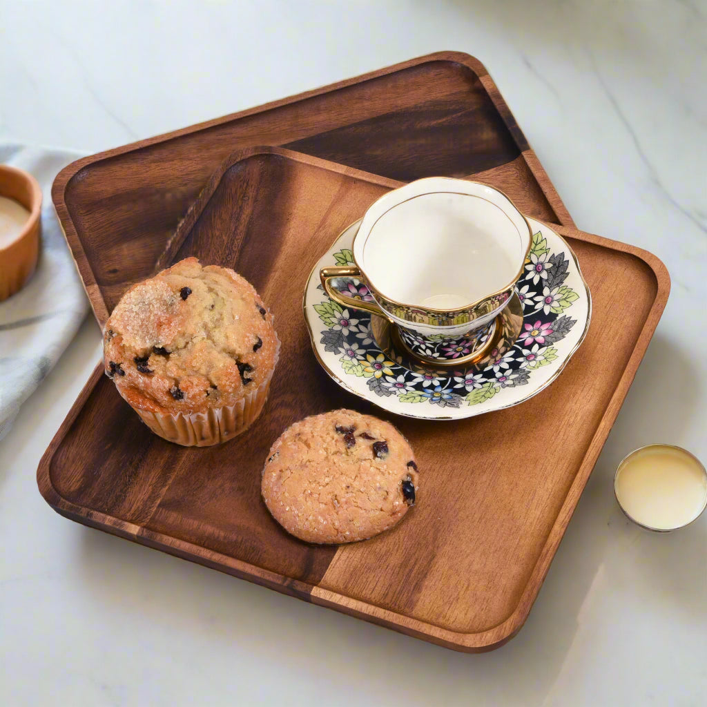 Two acacia wood square plates with natural grain and smooth edges for serving.