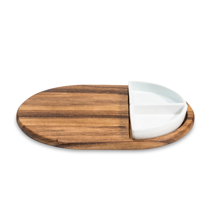 Acacia charcuterie board with two triangular ceramic bowls for serving snacks.