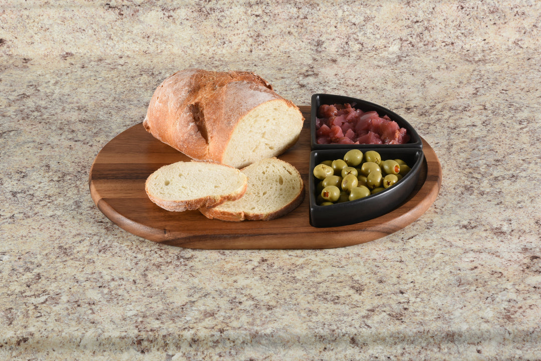Acacia charcuterie board with two triangular ceramic bowls for cheese, meats, and snacks.