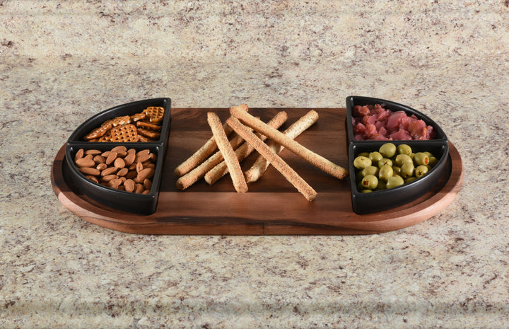 Acacia charcuterie board with four triangular ceramic bowls arranged for serving.