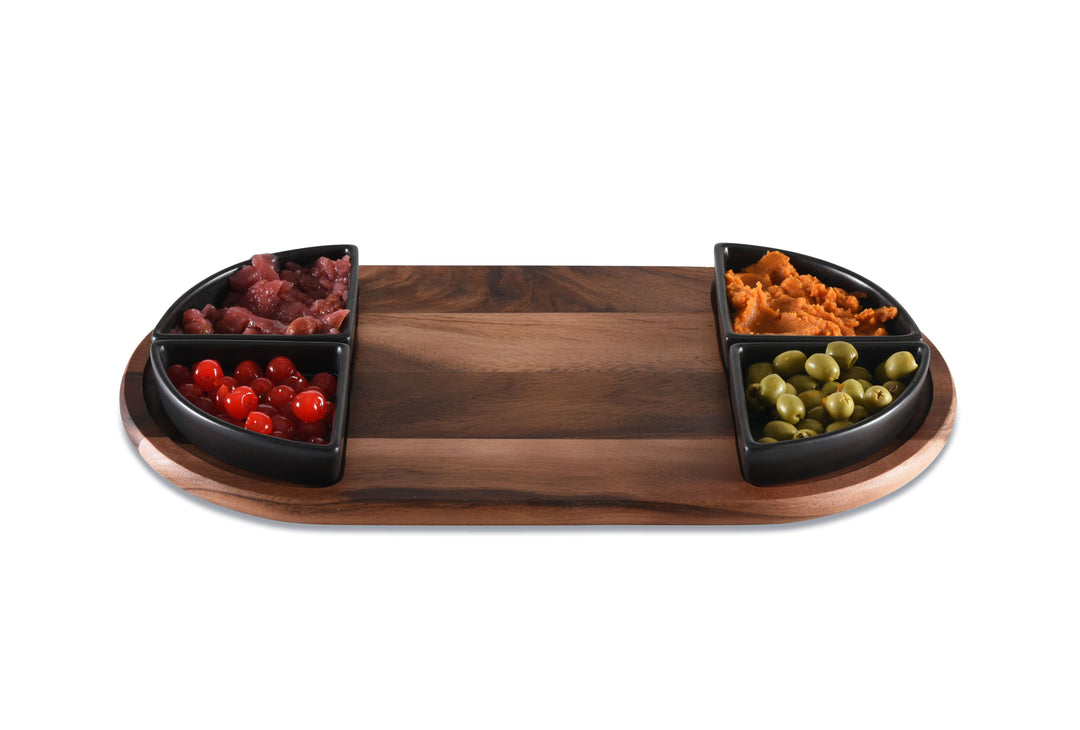Acacia charcuterie board with four triangular ceramic bowls for serving appetizers.