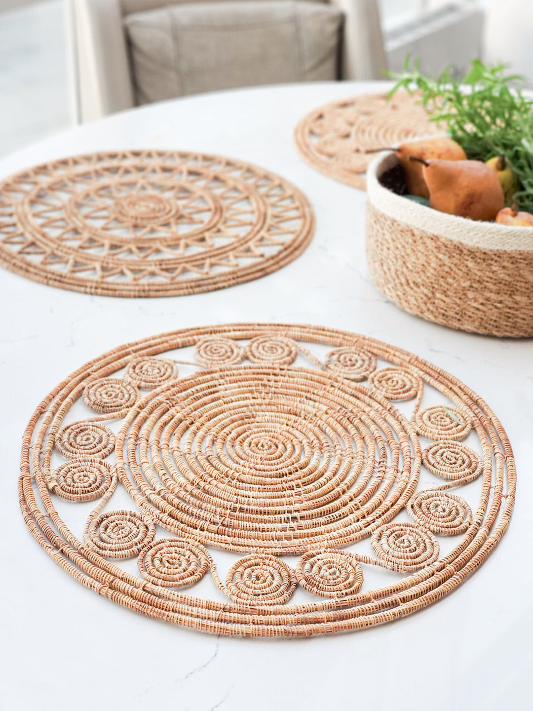 Round natural palm fiber placemats with spiral medallion perimeter detail, set of 2