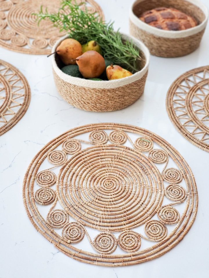 Handwoven palm fiber placemats with coiled medallion edge detail, natural straw, set of 2