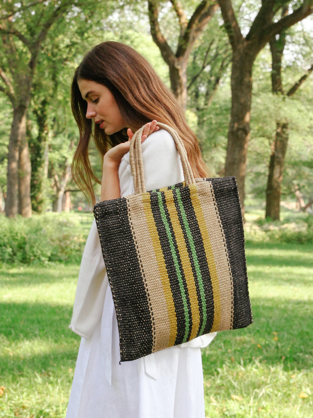 Hand-loomed jute tote in dark navy with bright vertical stripe accent