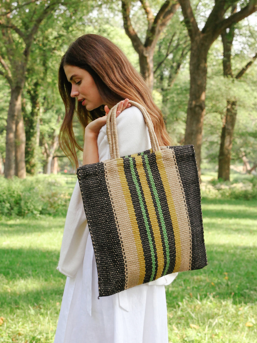 Hand-loomed jute tote in dark navy with bright vertical stripe accent