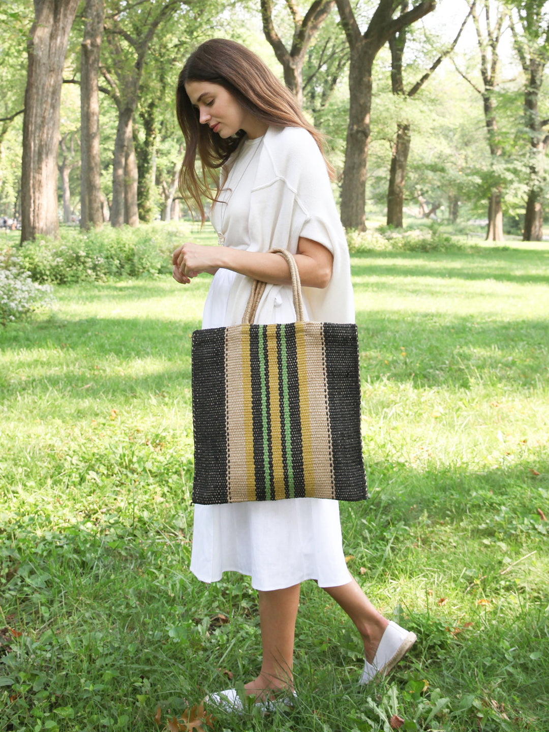 Striped jute tote bag with navy base and cream, yellow, and green center stripes