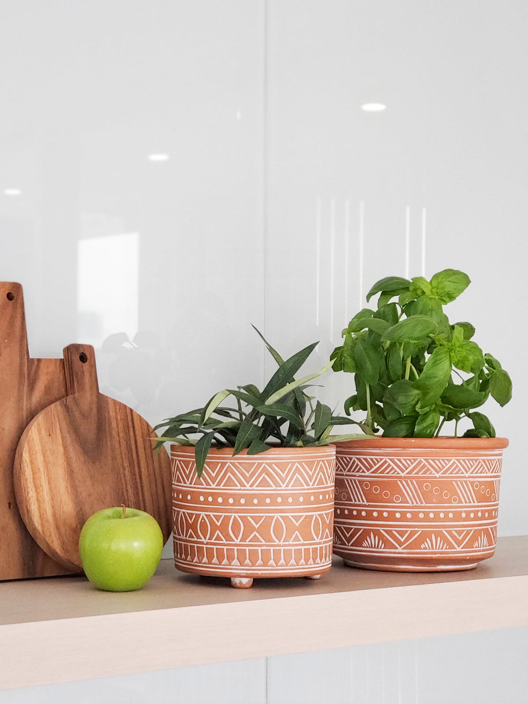 Large hand-etched terracotta pot with carved patterns and a rustic finish