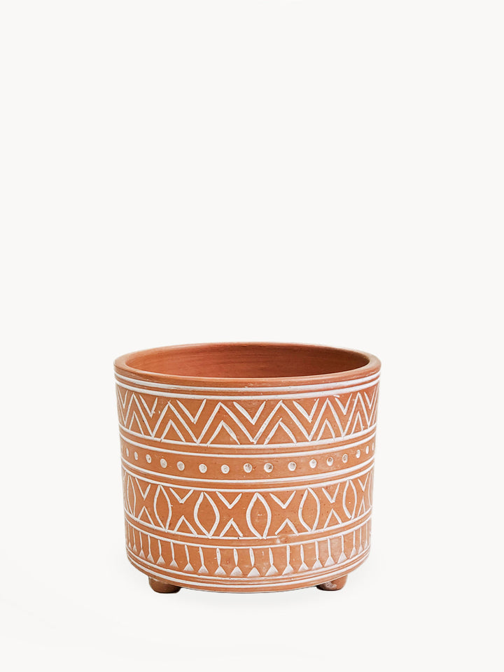 Small hand-etched terracotta pot with an intricate geometric design