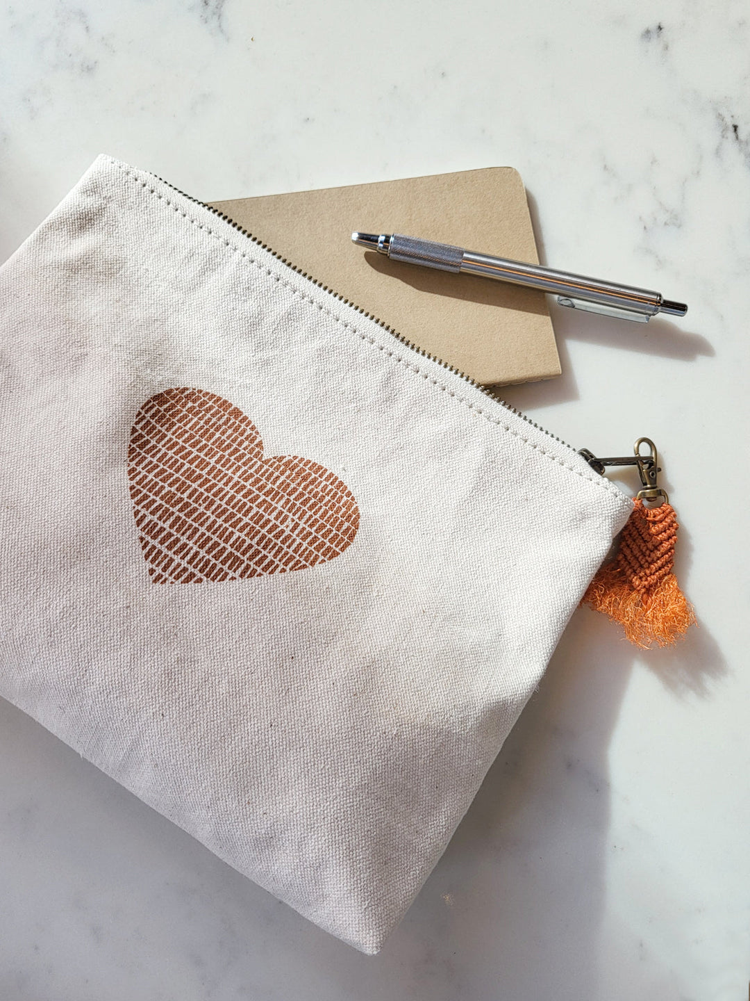 Cotton canvas zip pouch with hand-printed love motif in warm cinnamon