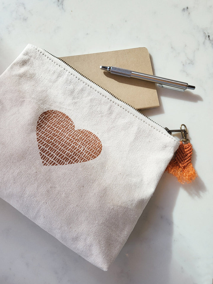 Cotton canvas zip pouch with hand-printed love motif in warm cinnamon