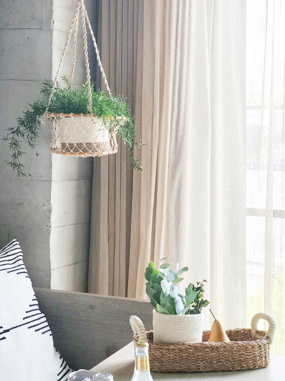 Natural jute hanging basket with a rounded silhouette and sturdy hanger