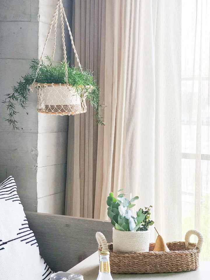 Natural jute hanging basket with a rounded silhouette and sturdy hanger