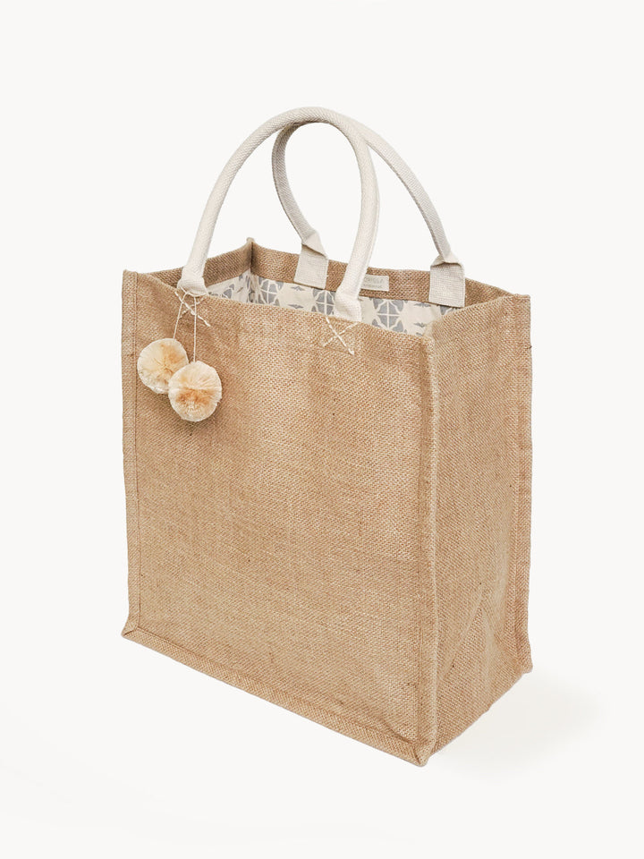 Spacious jute canvas market bag with colorful pompoms and sturdy handles