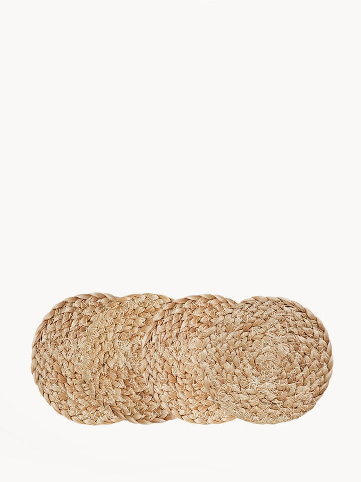 Set of 4 braided jute drink coasters in natural color, classic flat braid pattern