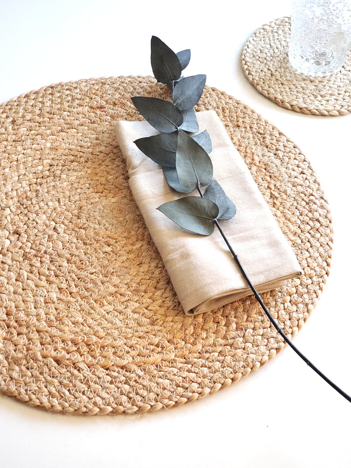 Set of four natural jute Kata round placemats by DC-KORISSA, showcasing textured eco-friendly table decor.