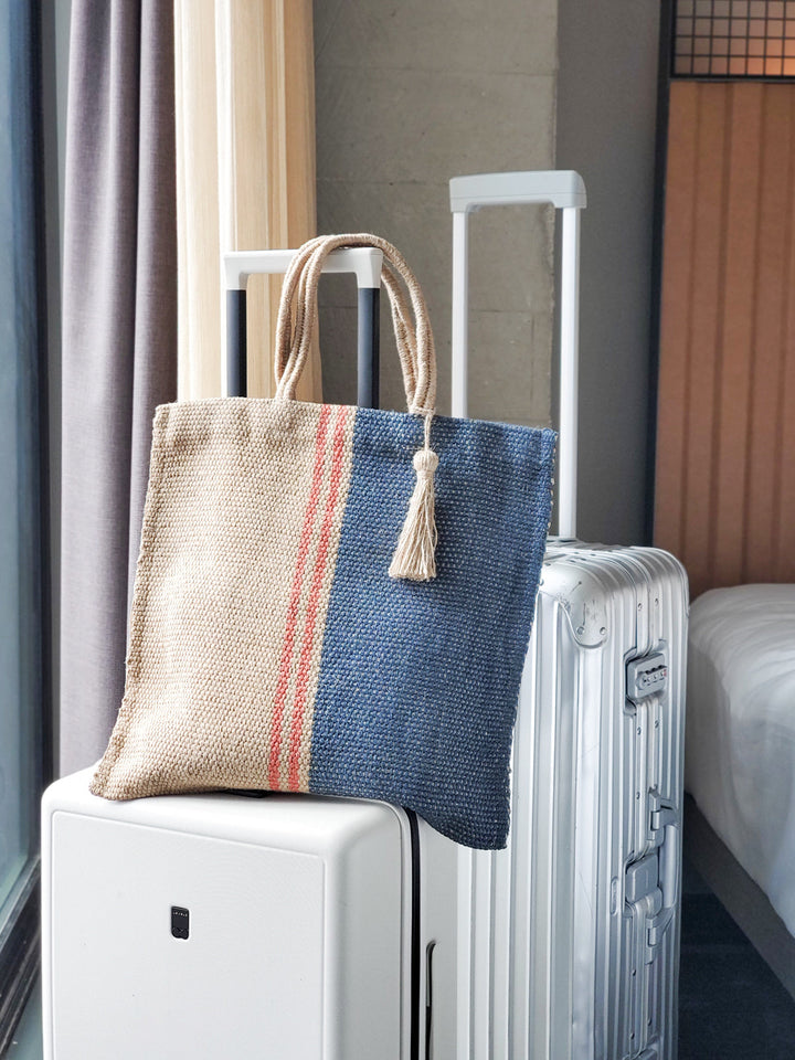 Color-block jute tote bag in navy and natural with vertical red stripe accents