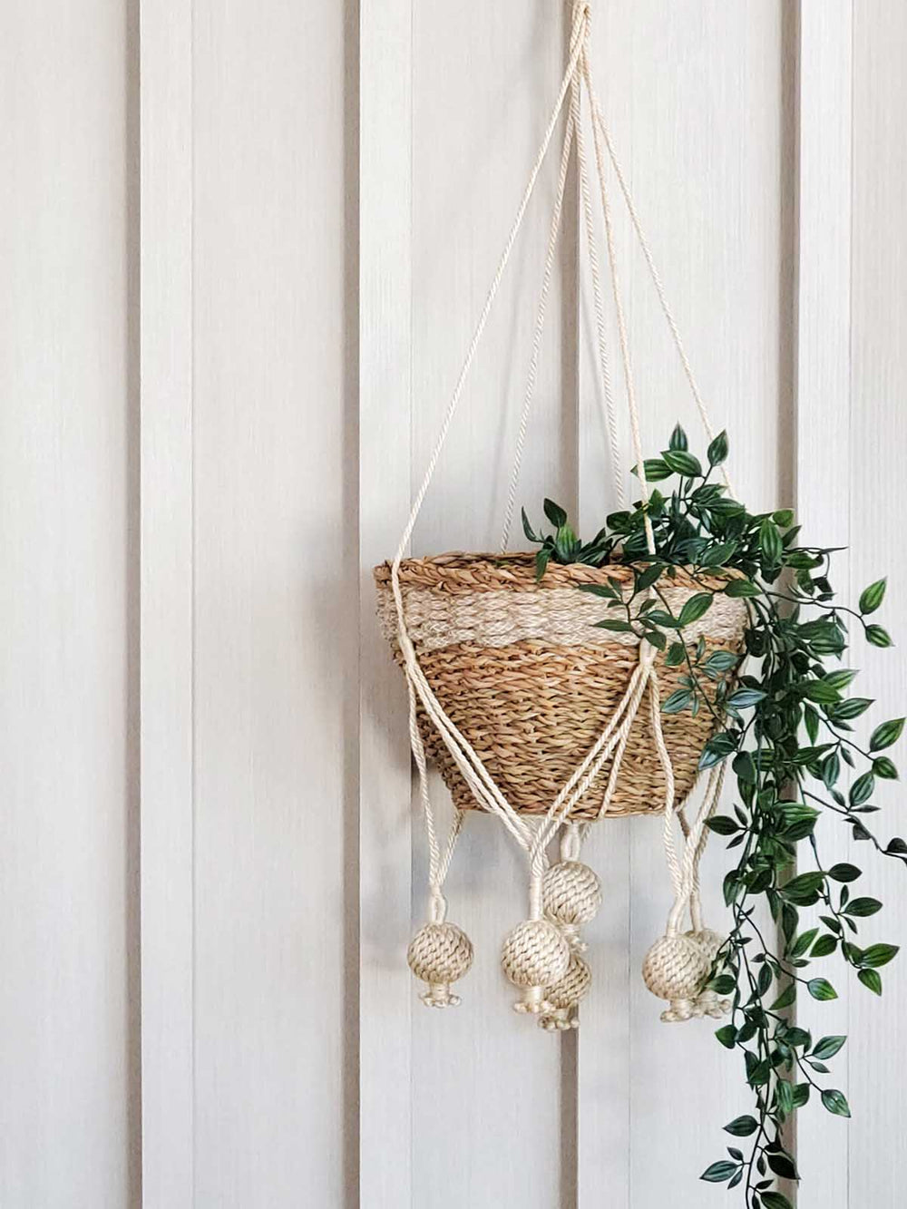 Jute plant hanger with large knot-ball decorations at the base