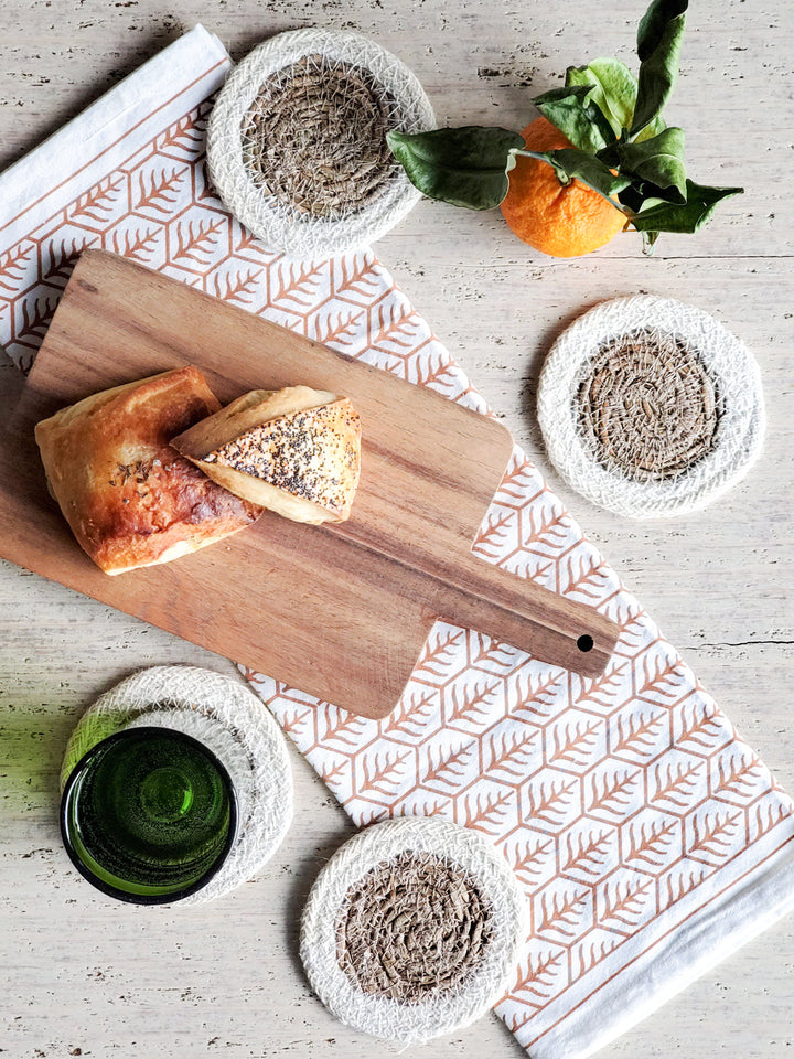Natural fiber drink coasters with seagrass center and braided cream border