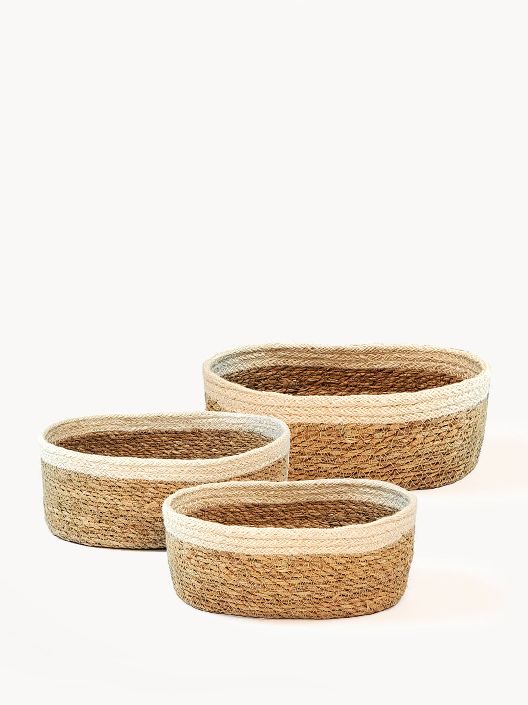Set of three oval seagrass nesting baskets, handwoven for bath and shelf storage