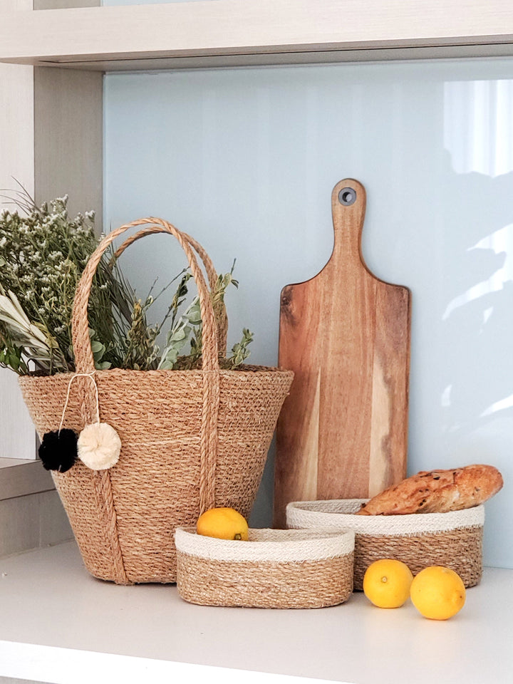 Set of three oval seagrass storage baskets by DC-KORISSA, natural woven baskets for organizing and decor.