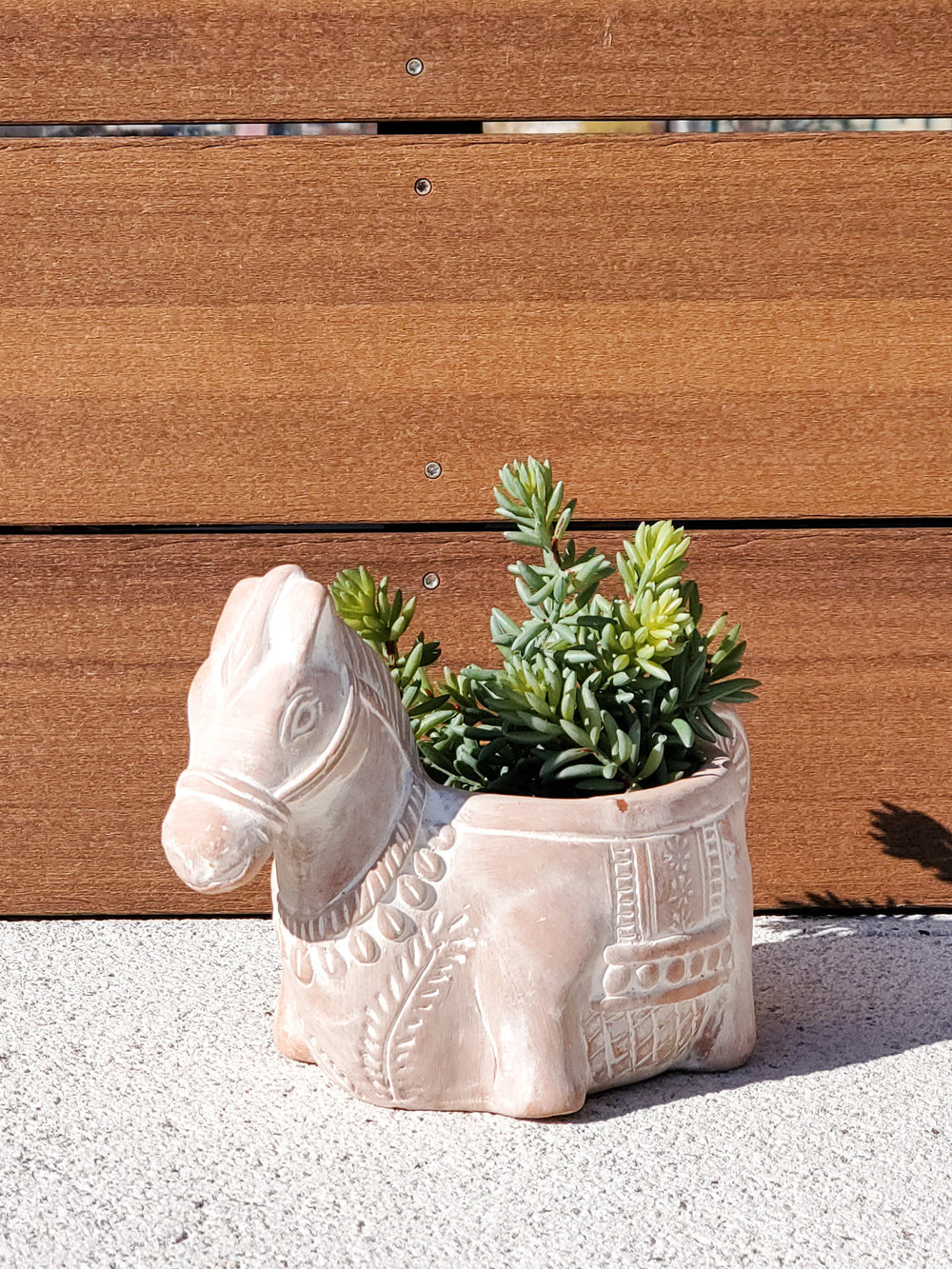 Horse-shaped terracotta planter with a rustic finish