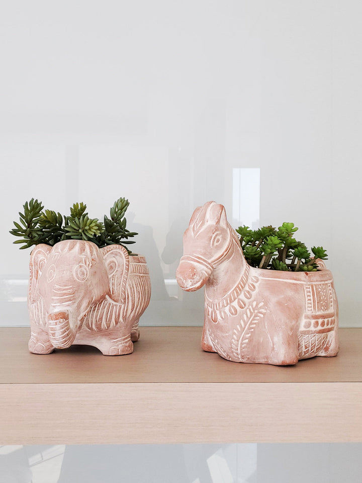 Horse-shaped terracotta planter in a warm clay color