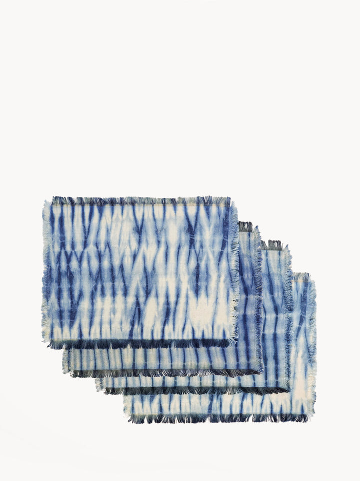 Shibori-dyed cotton placemats in indigo blue with geometric pattern and fringed edges, set of 4