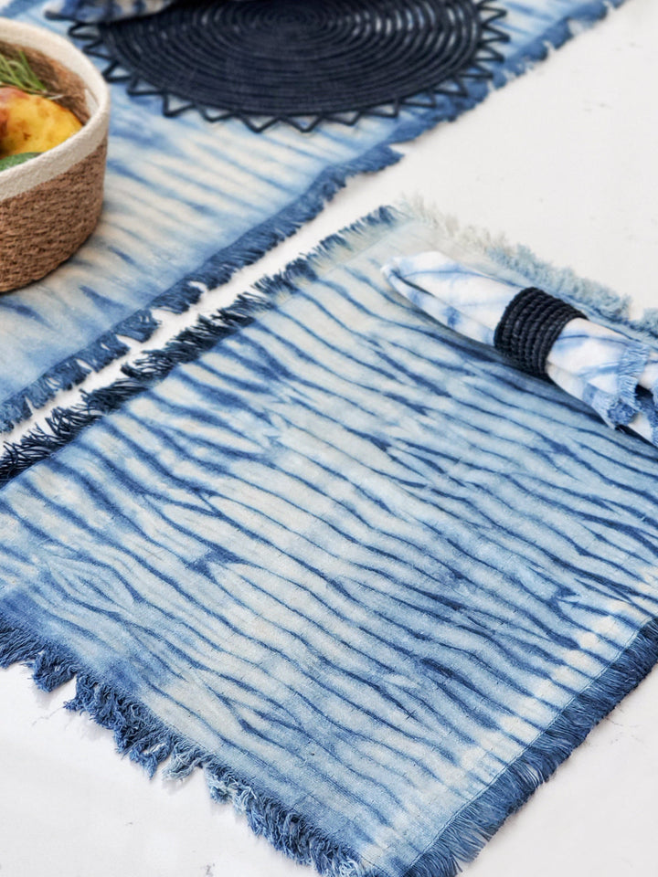 Indigo shibori cotton placemats with bold dye pattern and fringed edges
