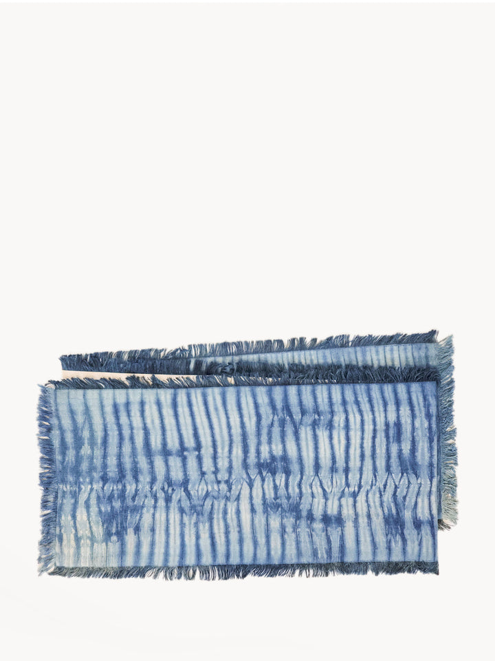 Fringed shibori-dyed cotton table runner in deep indigo and white