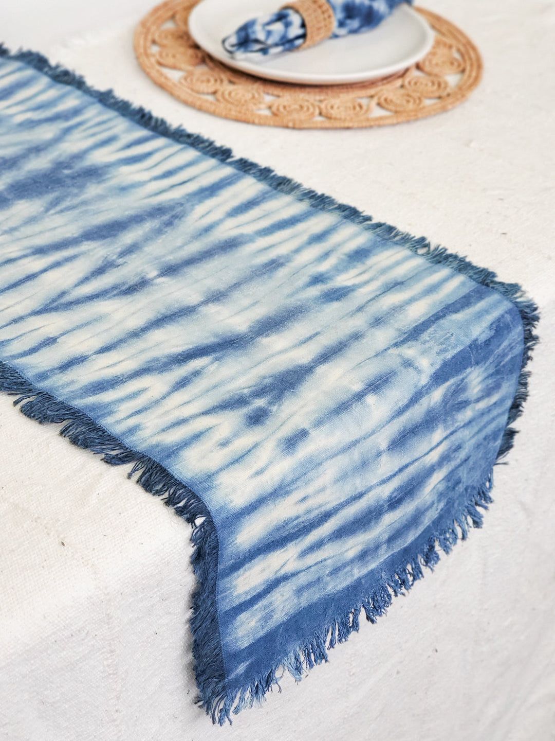 Indigo blue shibori cotton table runner displayed flat on table
