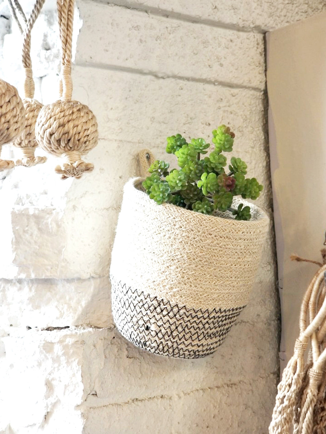 Off-white loop jute storage bin with black stitching
