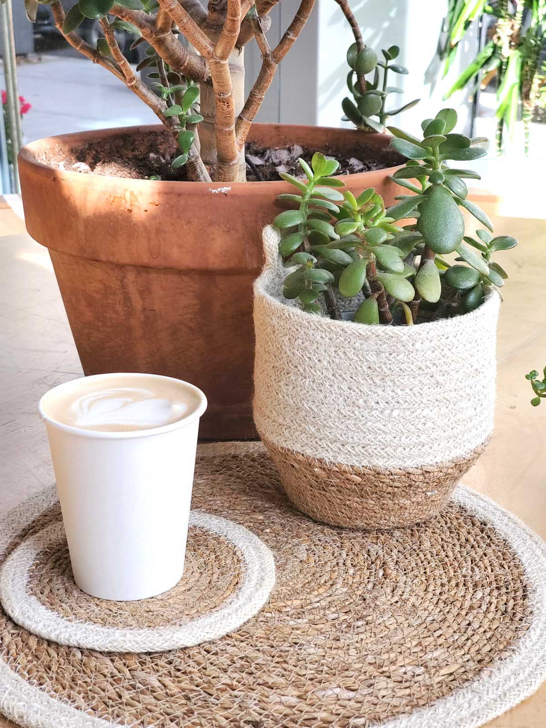 Round natural jute loop storage bin with a neutral finish
