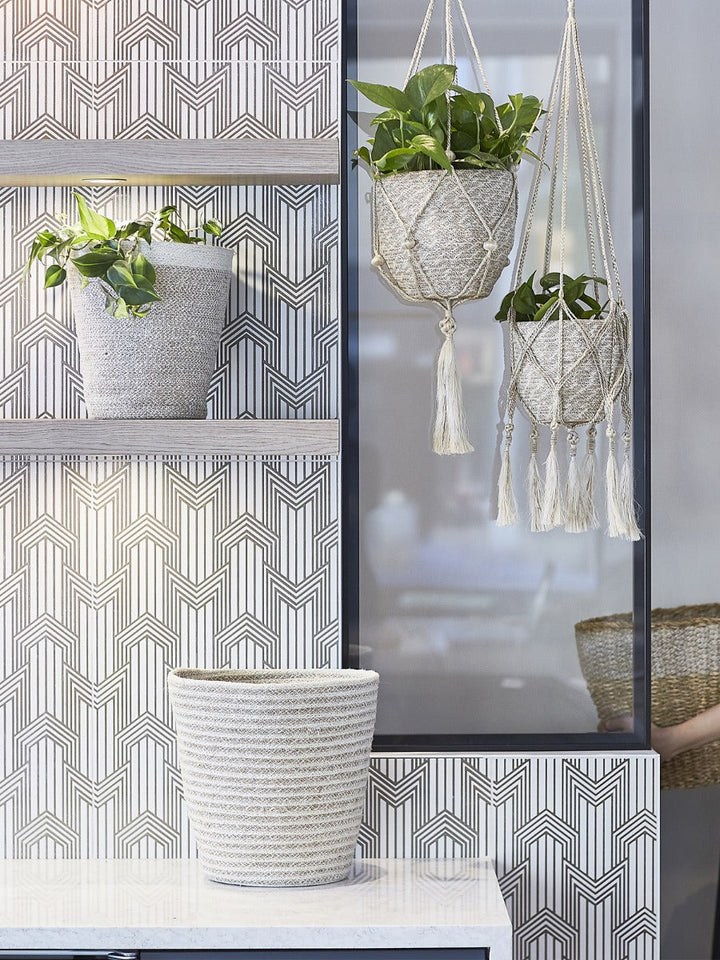 Macrame jute plant hanger with criss-cross pattern and fringe detail