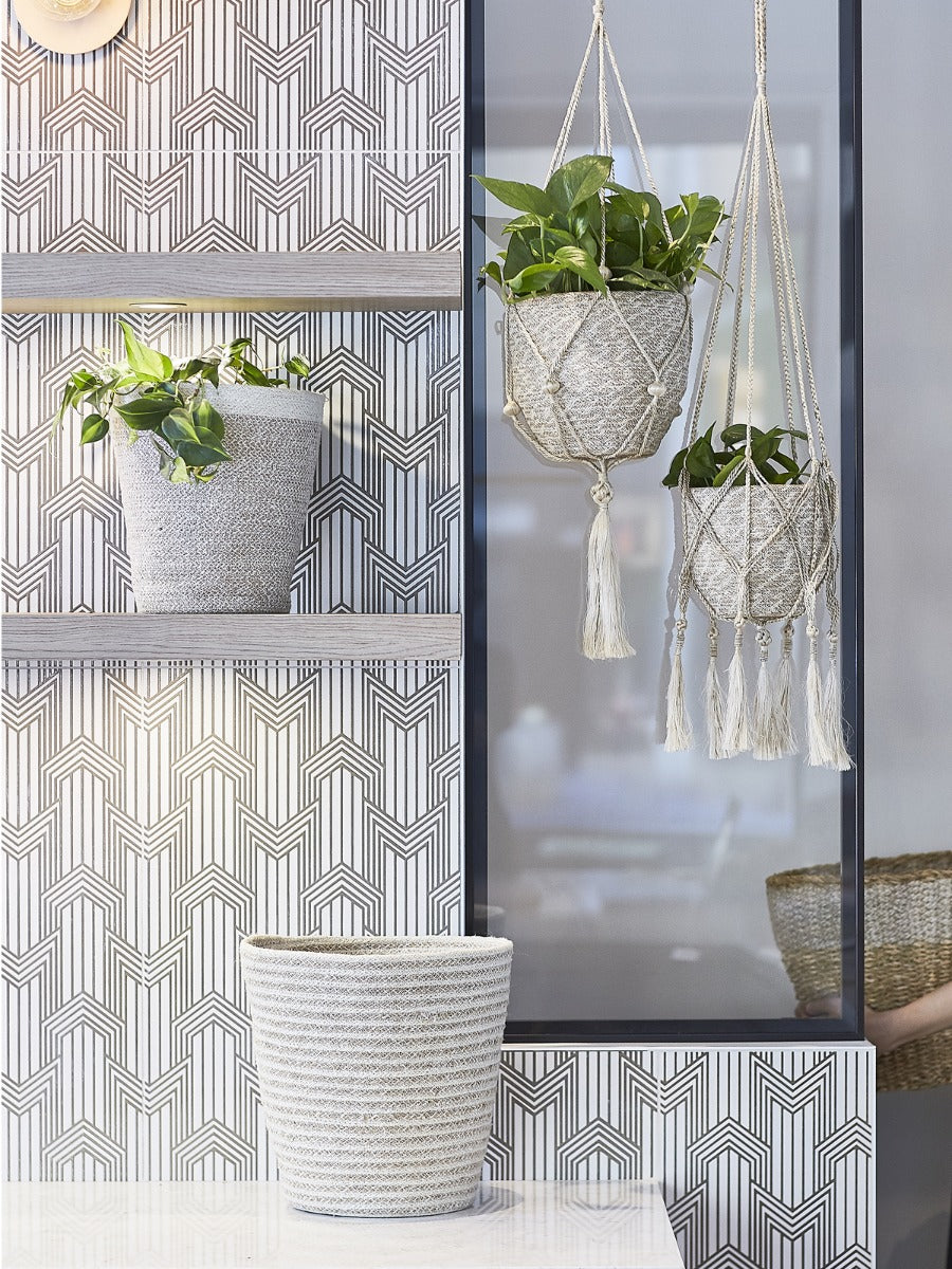 Round handwoven jute bin in white and natural tones