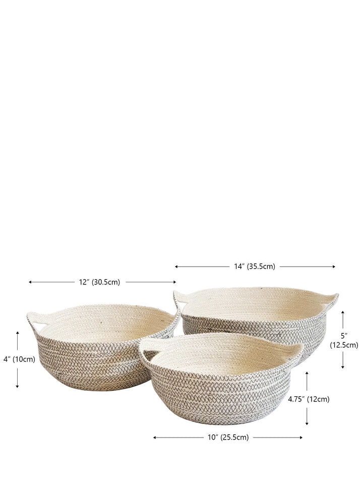 Handwoven storage bowl in off-white jute with black stitch trim