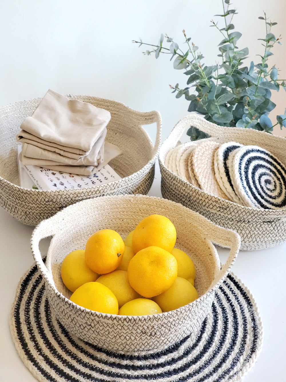 Small jute fruit bowl with contrasting black stitching, hand-braided