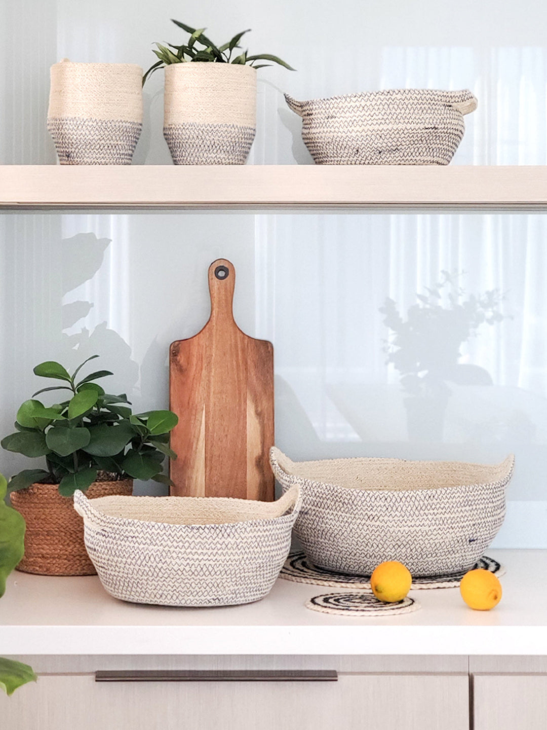 Off-white jute storage bowl with horizontal black stitch pattern