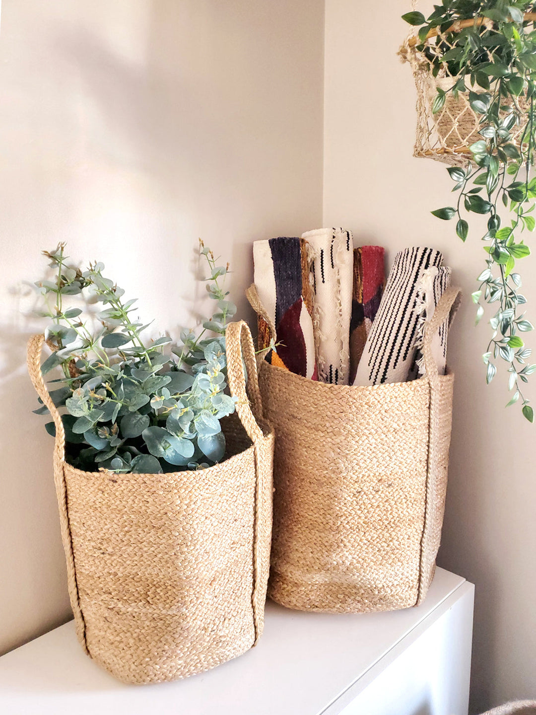 Hand-braided jute basket with sturdy carry handles for room-to-room storage
