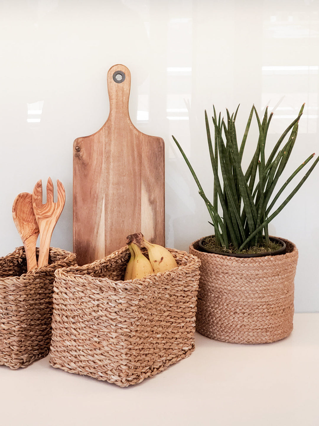 Small round jute storage basket with woven handles and sturdy braided construction