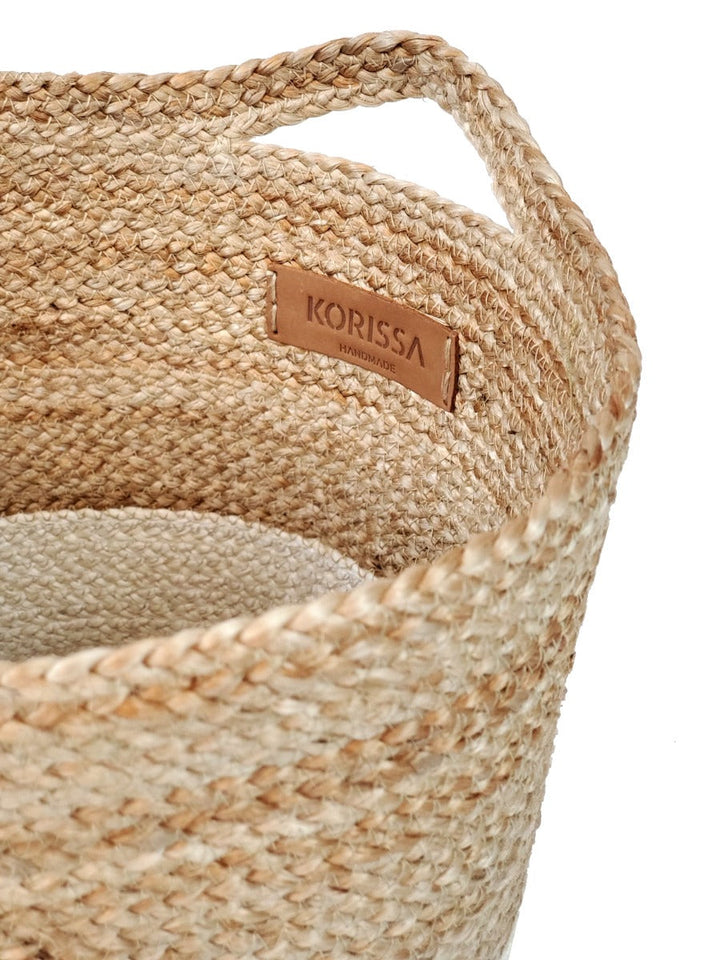 Sturdy woven jute storage basket with crisp white colorblock band