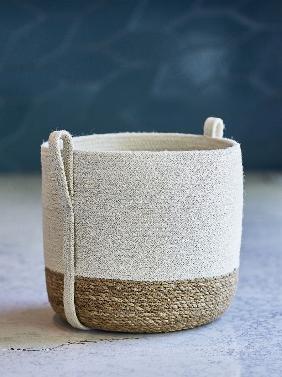 Small natural fiber storage basket with side handles by DC-KORISSA, featuring a woven design and sturdy build for organizing items.