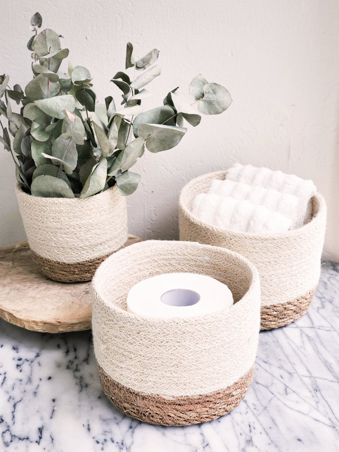 Small round storage basket made of natural seagrass by DC-KORISSA, perfect for organizing or decorative storage.