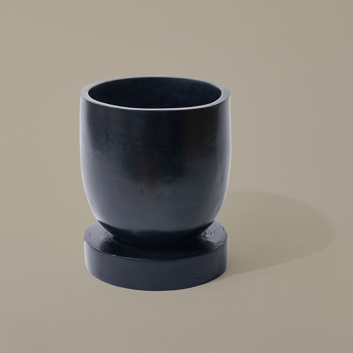 Hand-carved Sese wood planter from Ghana with a dark soot-stained finish.